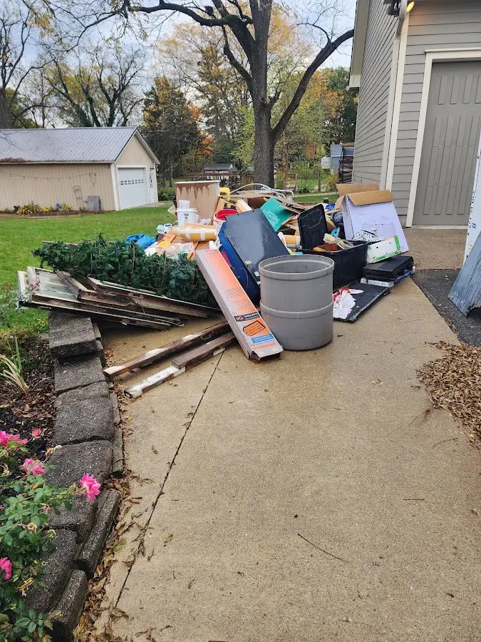 Dumpster being loaded with debris for Roofing Dumpster Rental in Clarkston